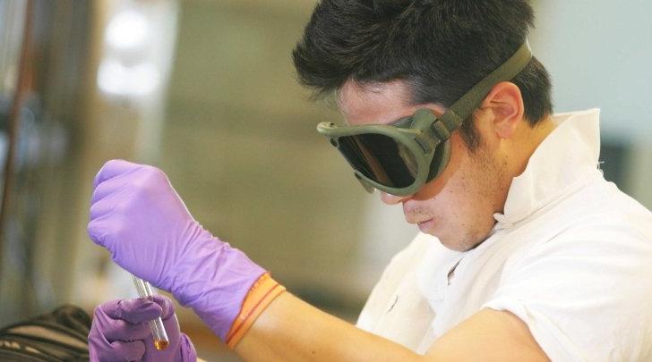 STEM student checks a lab vial